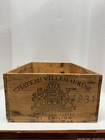 Front view of the wooden wine crate showing Chateau Villemaurine branding and crest.