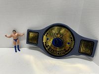 Jakks WWF Championship belt and Andre the Giant bendable figure shown side by side on a white surface.