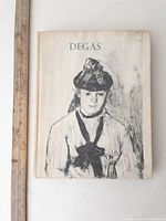 Front cover of the vintage Degas art book showing a monochrome portrait sketch on a softcover.