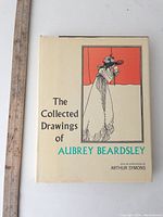 Front cover of "The Collected Drawings of Aubrey Beardsley" showing title, illustration, and author appreciation by Arthur Symons.