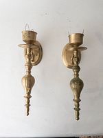 Front view of the set of 2 brass wall sconces side by side showing overall design and condition.