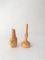 Front view of the two mini turned wood vases on white background showing shape and wood grain