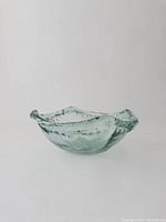Side view of recycled glass bowl showing textured and thick edges and irregular organic shape.