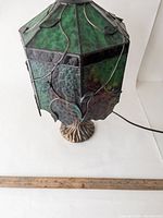 Front angle view showing hexagonal shade panels and tree trunk base