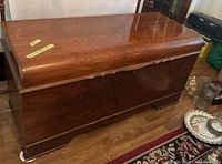 Full front view of polished wood cedar chest showing its shape and condition.