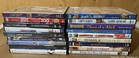 Front view of 23 assorted DVDs showing titles and condition of cases