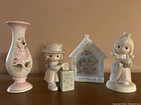 Photo showing full set of four items: hand painted bud vase, girl figurine with ballot box, house-shaped frame with girl and zebra, and girl figurine in pink dress.