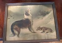 Full view of the framed print showing shepherd dog standing and lamb lying in snow.