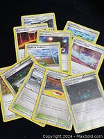 Photo of 11 uncommon Stadium and other Pokémon Trainer cards fanned out showing card fronts.