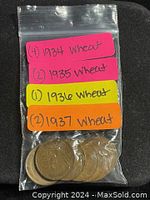Clear photo of the 9 copper Wheat pennies inside a labeled plastic bag with year and quantity notes.