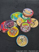Top-down view of colorful POGS game pieces with various cartoon and bee illustrations.