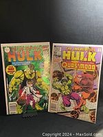Two vintage Marvel comic books featuring The Incredible Hulk. One is The Incredible Hulk #340, showing Hulk and Bruce Banner on the cover. The other is The Incredible Hulk versus Quasimodo #1, featuring Hulk fighting Quasimodo on the cover.