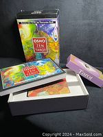 Full view of the Osho Zen Tarot box, tarot cards spread, and instruction booklet