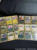 Top-down view of 27 uncommon Pokémon cards spread and layered, clear details of Pokémon characters and attack points.