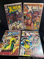 Four X-Men Adventures comic books arranged in grid, showing colorful covers with various characters and titles.