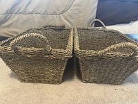 Two rectangular sea grass baskets side by side showing woven texture and shape with integrated handles on short sides.