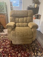 Front view of the La-Z-Boy recliner chair showing tufted cushions, brown fabric, and wide armrests.