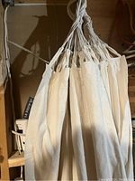 Close-up of the hammock hanging ropes and canvas fabric showing construction details.