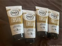 Four upright tubes of Magic Razorless Cream Shave showing front labels.