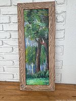 Full view of vertical original oil painting in wooden frame, showing green tree landscape with textured brushwork.