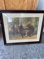 Full view of framed picture of dancing bears in a forest, showing the entire artwork and frame.