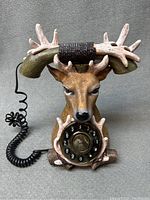 Front view of the deer buck antler telephone showing the full body bust with rotary dial and handset shaped like antlers.