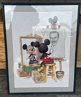 Full view of framed Mickey Mouse wall art print showing Mickey painting portrait of Walt Disney with artist tools and reflection in mirror.