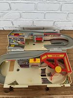 Top-down view of the Hot Wheels Car Wash playset showing the curved racing ramp, car wash and blow dry sections, and control components.