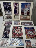 Full overview of 9 matted sports photos and prints from 2000-2004 in plastic wrap.