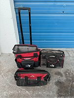 Three Husky tool bags grouped together showing front and top views, against blue garage door background