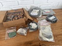 Various packaged aviation gaskets and rubber seals on a wooden surface