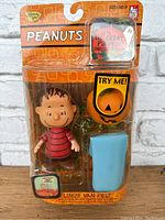 Front view of Peanuts Linus Van Pelt Halloween action figure in sealed original blister pack, showing figure, pumpkin accessory, and blue blanket.