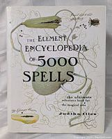 Front cover of The Element Encyclopedia of 5000 Spells showing title, author, and botanical illustrations.