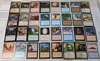 Photo of front sides of 41 Magic The Gathering cards with various creatures, spells, and effects visible.