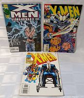 Three Marvel X-Men comic books shown from front covers, each featuring different characters and themes.