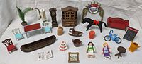 Photo showing all Playmobil toy pieces including furniture, figures, and accessories arranged on a white background.