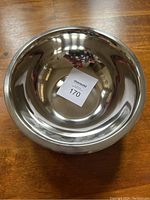 Top view showing a single polished metal mixing bowl with a label inside.