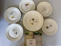 Full overview of all six appetizer plates and boxed set of six glass cocktail stir sticks