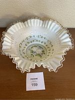 Top view of the large Fenton Silvercrest bowl showing the hand painted floral design inside and ruffled silver-trimmed edge.