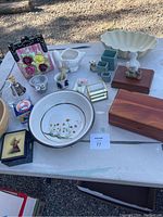 Table display of assorted pottery, decor, and wooden boxes showing all items in the lot.