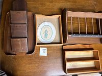 Top view of multiple wooden items on a table including trays, racks, organizer and framed picture.