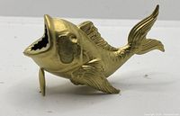 Side view of gold fish bottle opener showing the body, fins, and open mouth.