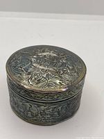 Top view showing detailed floral and leaf embossing on lid and body of the box.