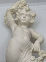 Close-up of the child's torso and lower arm holding cloth and flowers.