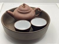 Top view of teapot, two cups and tray showing set composition and condition.