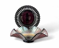 Front view of black amethyst openwork plate and amethyst carnival glass dish displayed together