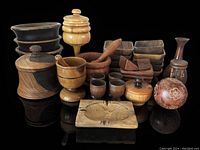 Photo showing full assortment of mid-century modern wooden serve ware and decor including lidded containers, bowls, mortars, pestles, small trays, timer, napkin rings, and carved ornament.