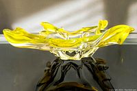 Side view showing free-form shape and bright yellow rim.