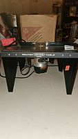 Wide shot of Craftsman router table showing black metal construction and mounted router underneath.