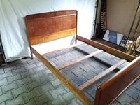 Full view of the bedframe showing headboard, side rails, and support slats